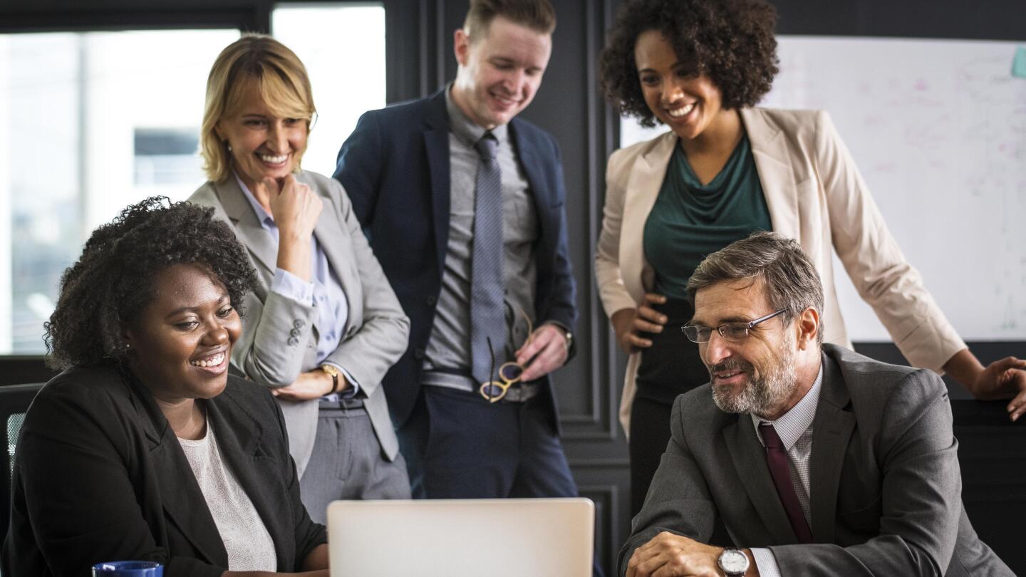 A small business group collaboratively analyzing digital solutions to improve accessibility.